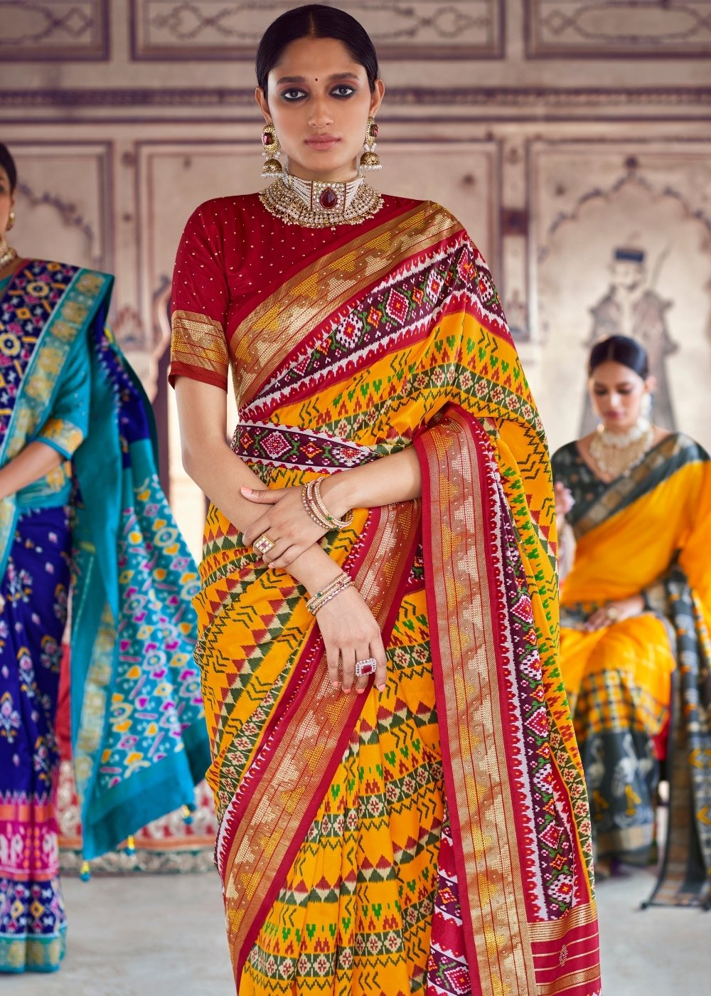 Saffron Yellow & Red Patola Silk Saree with Zari Border Pallu & Stone work