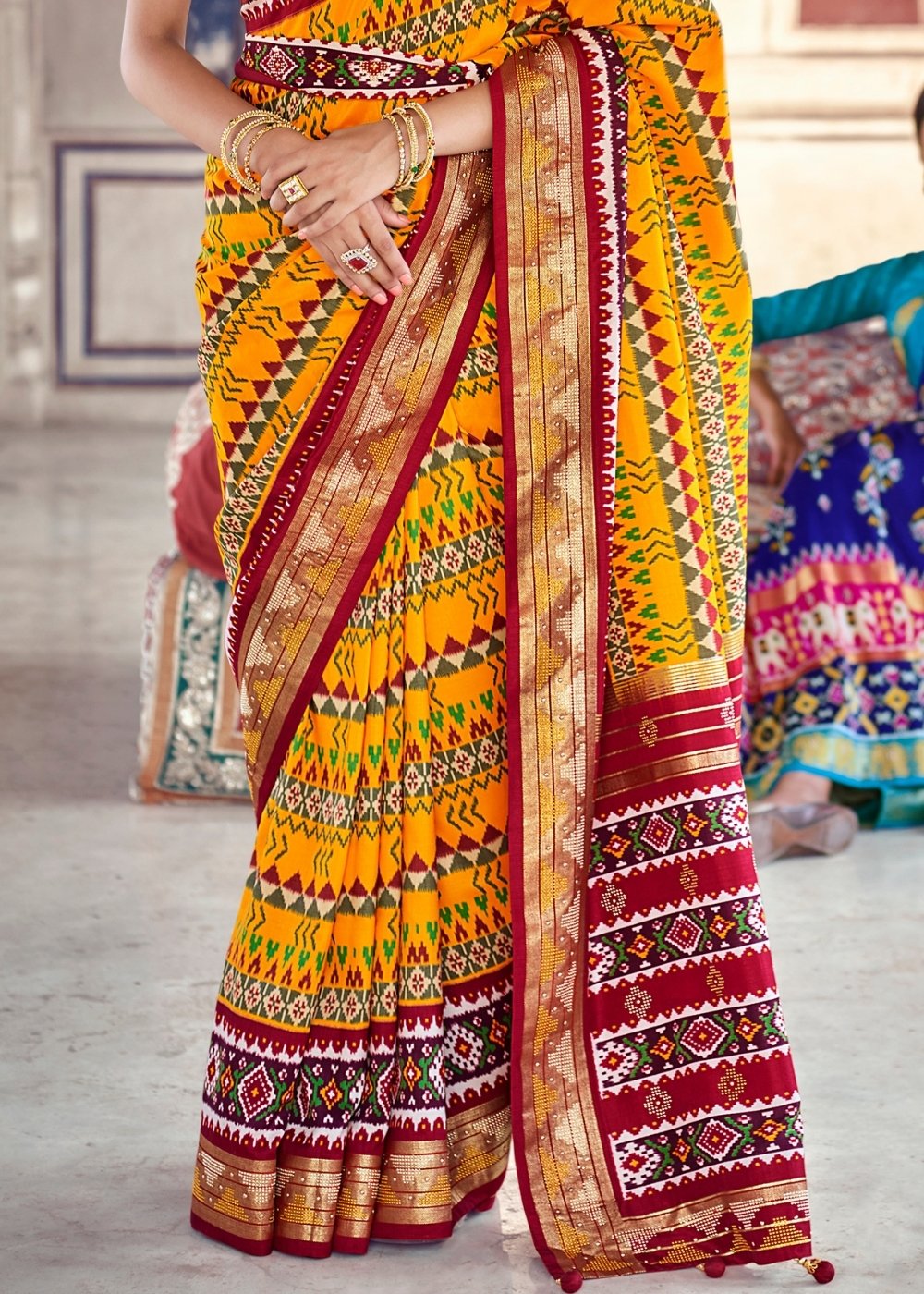 Saffron Yellow & Red Patola Silk Saree with Zari Border Pallu & Stone work