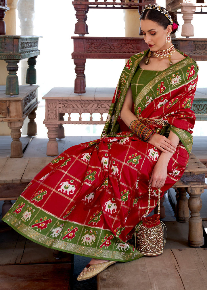 Crimson Red Printed Patola Silk Saree with Zari Border & Tassels on Pallu