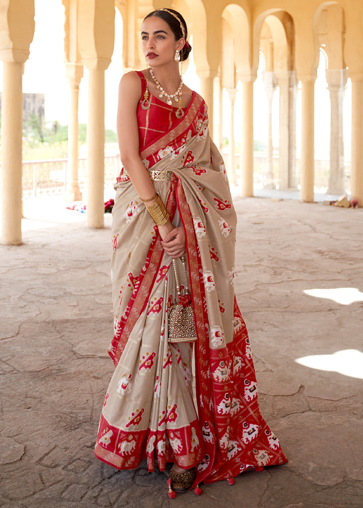 Oat Brown Printed Patola Silk Saree with Zari Border & Tassels on Pallu