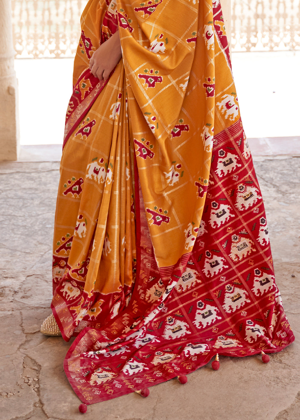 Honey Orange Printed Patola Silk Saree with Zari Border & Tassels on Pallu