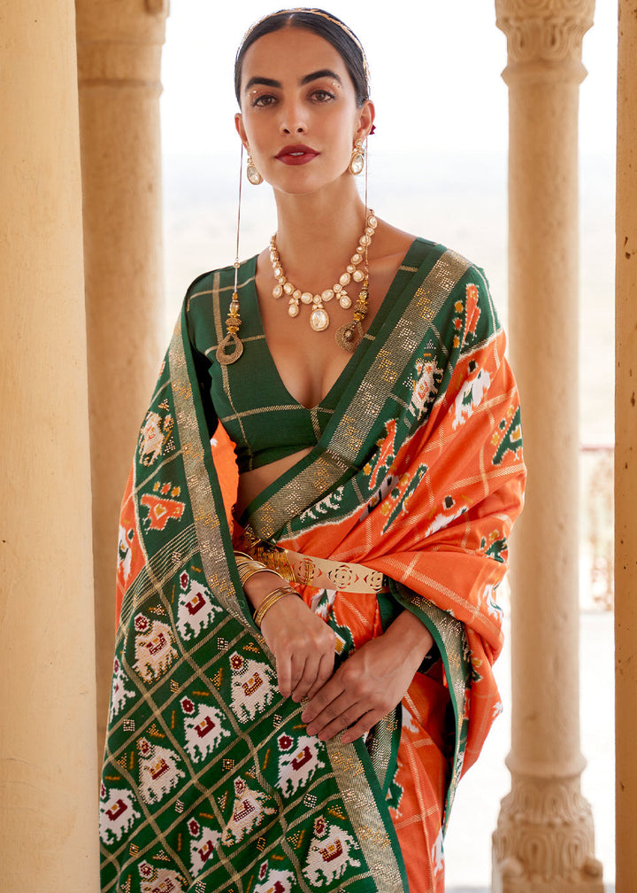 Pumpkin Orange Printed Patola Silk Saree with Zari Border & Tassels on Pallu