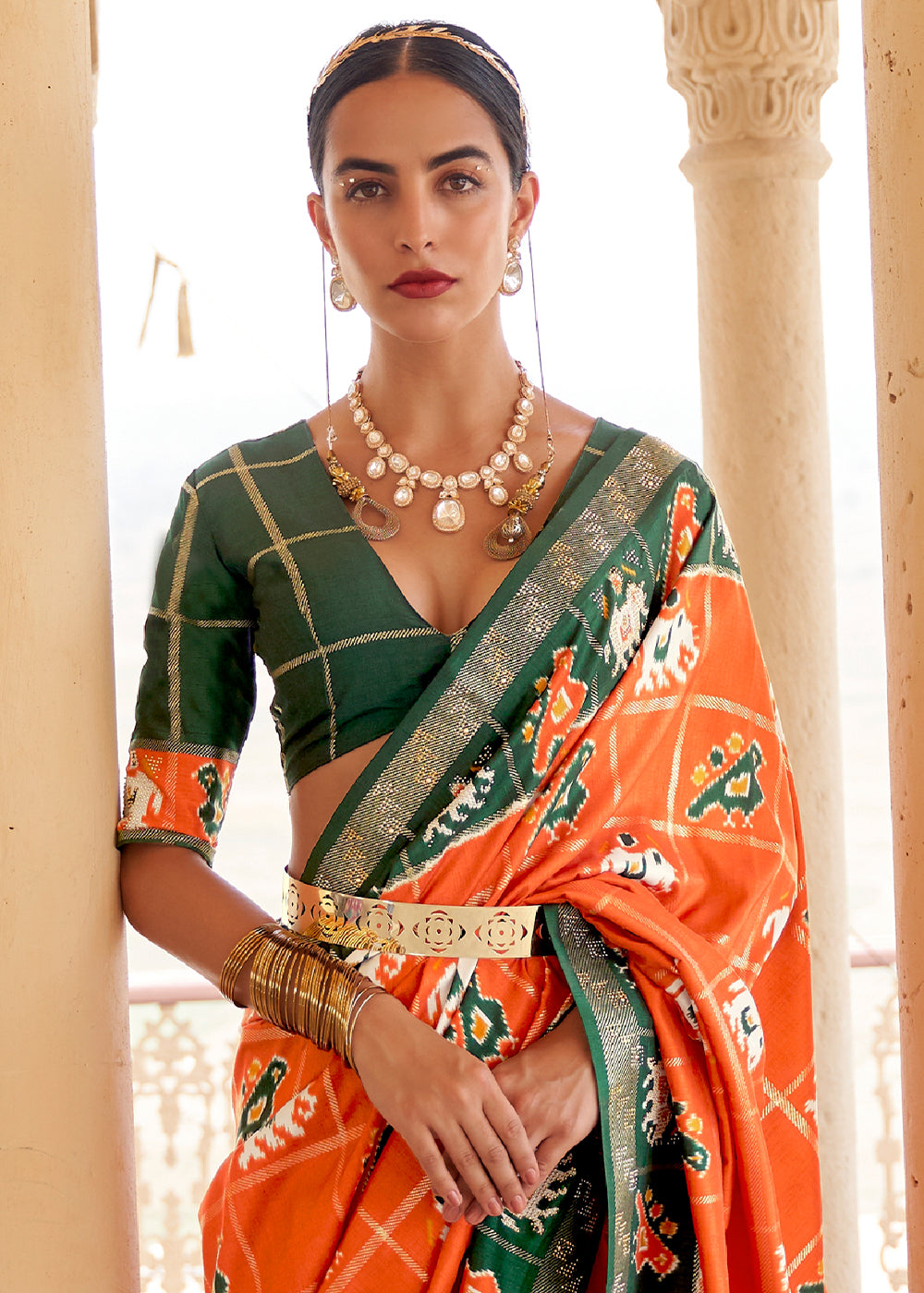 Pumpkin Orange Printed Patola Silk Saree with Zari Border & Tassels on Pallu