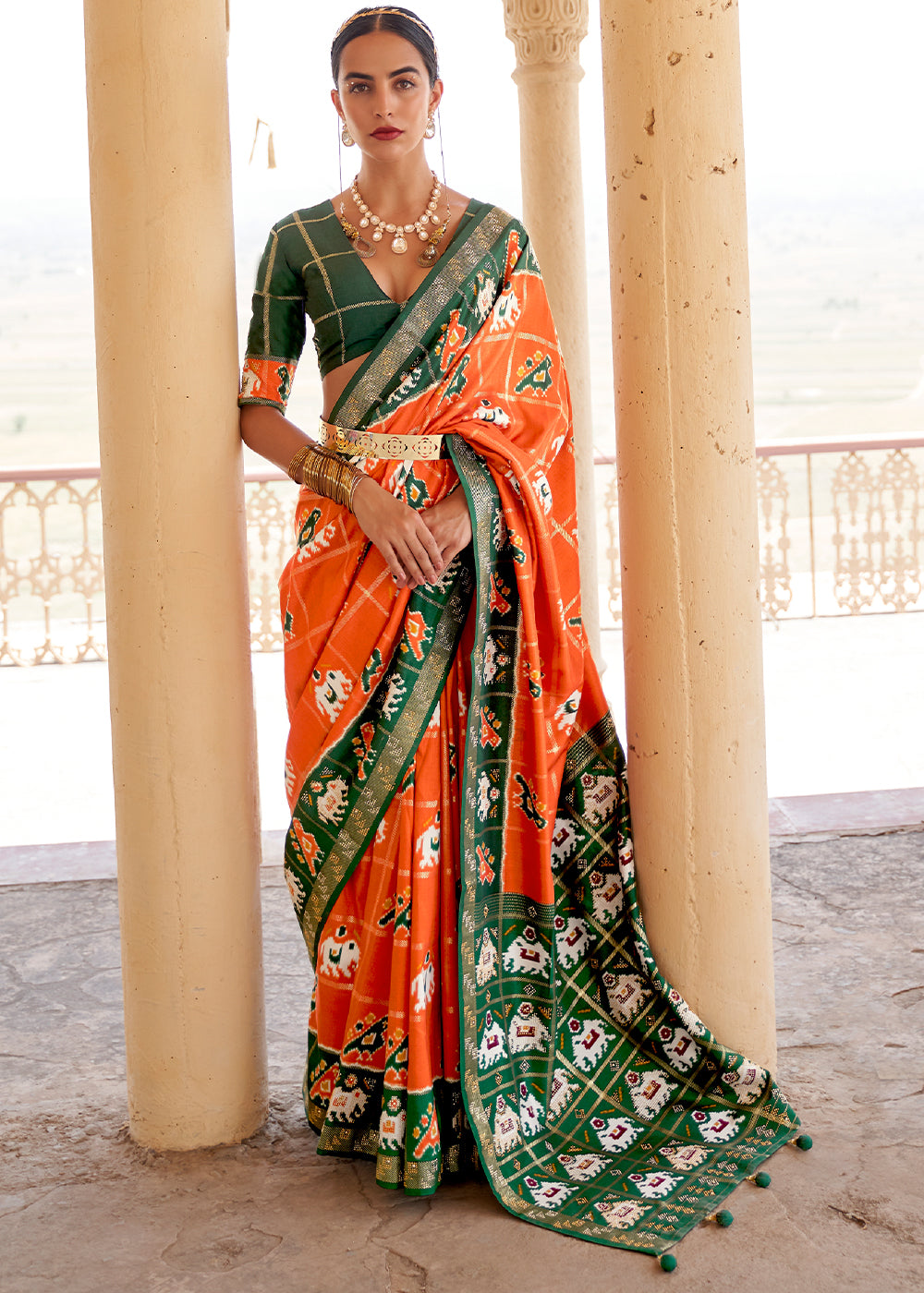 Pumpkin Orange Printed Patola Silk Saree with Zari Border & Tassels on Pallu